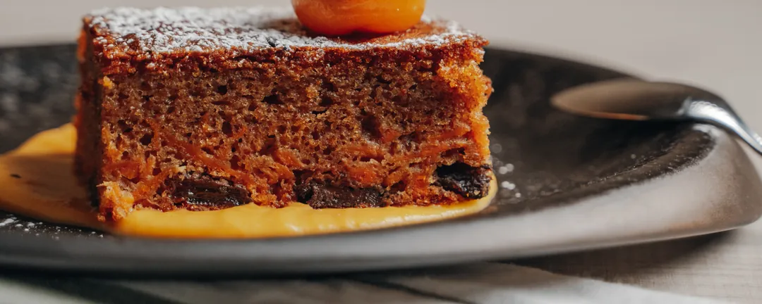 A sponge cake topped with a kumquat